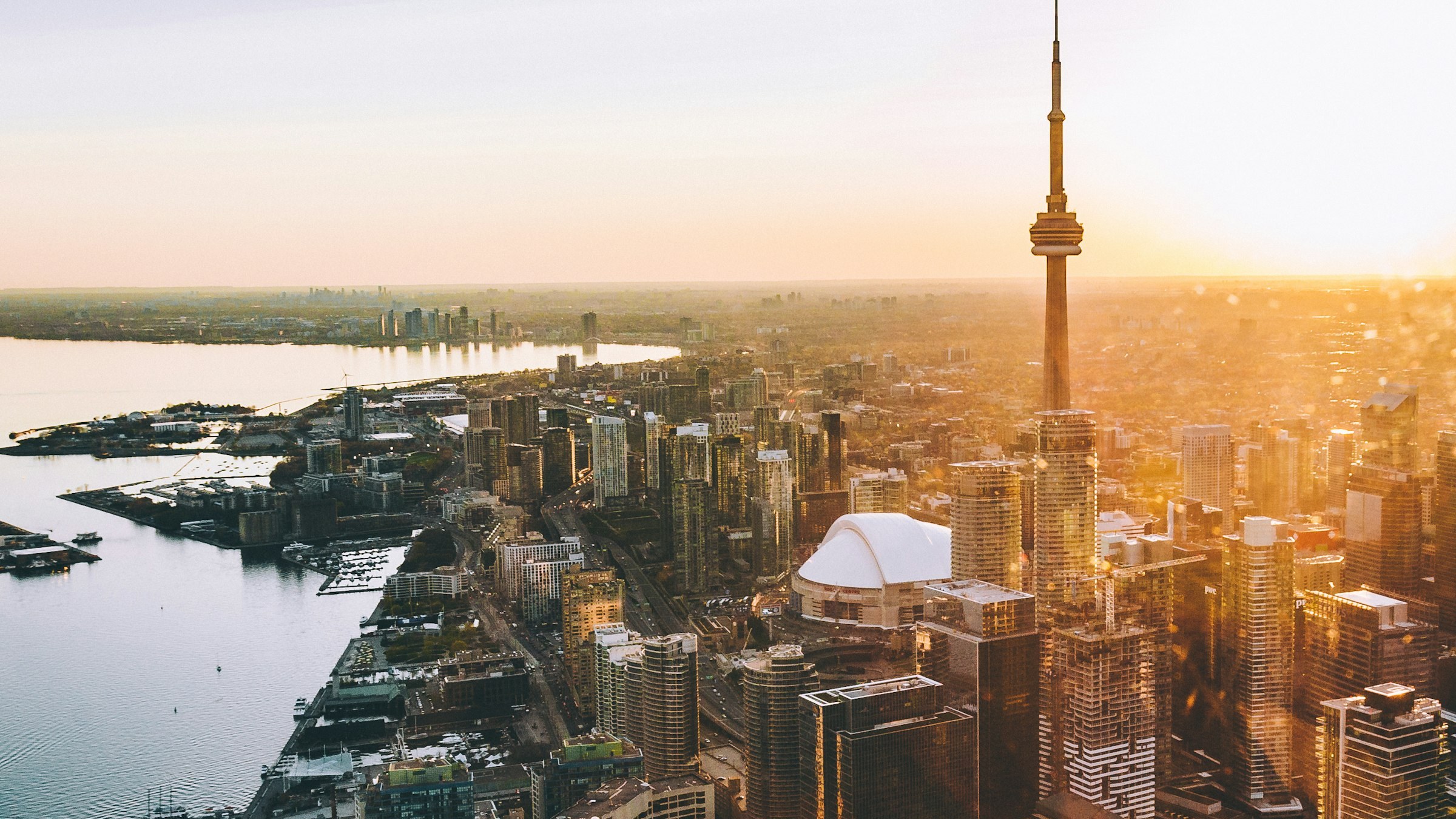 Toronto skyline at sunset with the CN Tower and Lake Ontario